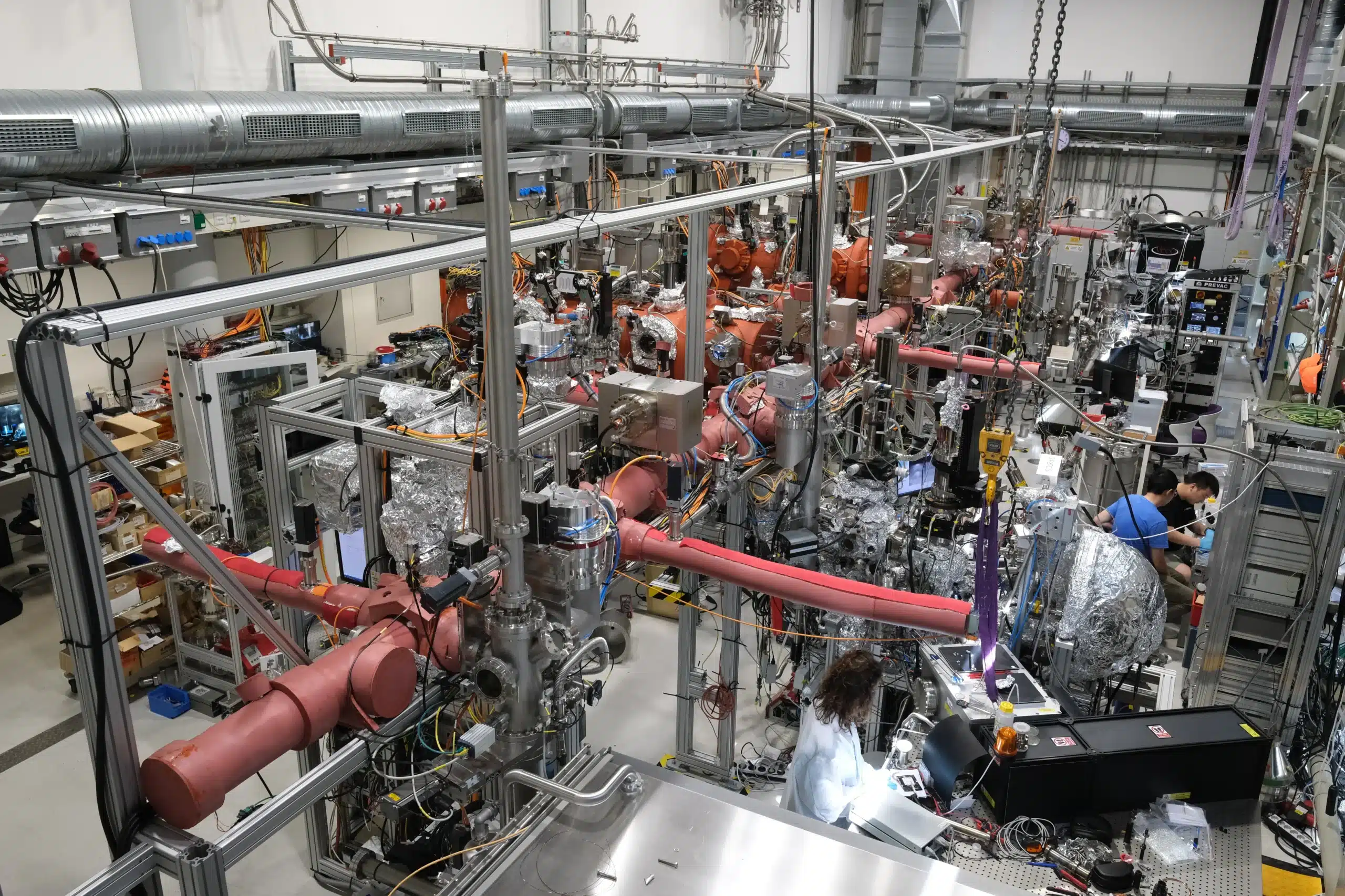 Researchers working among scientific equipment in the Experimental Hall at MPI of Microstructure Physics